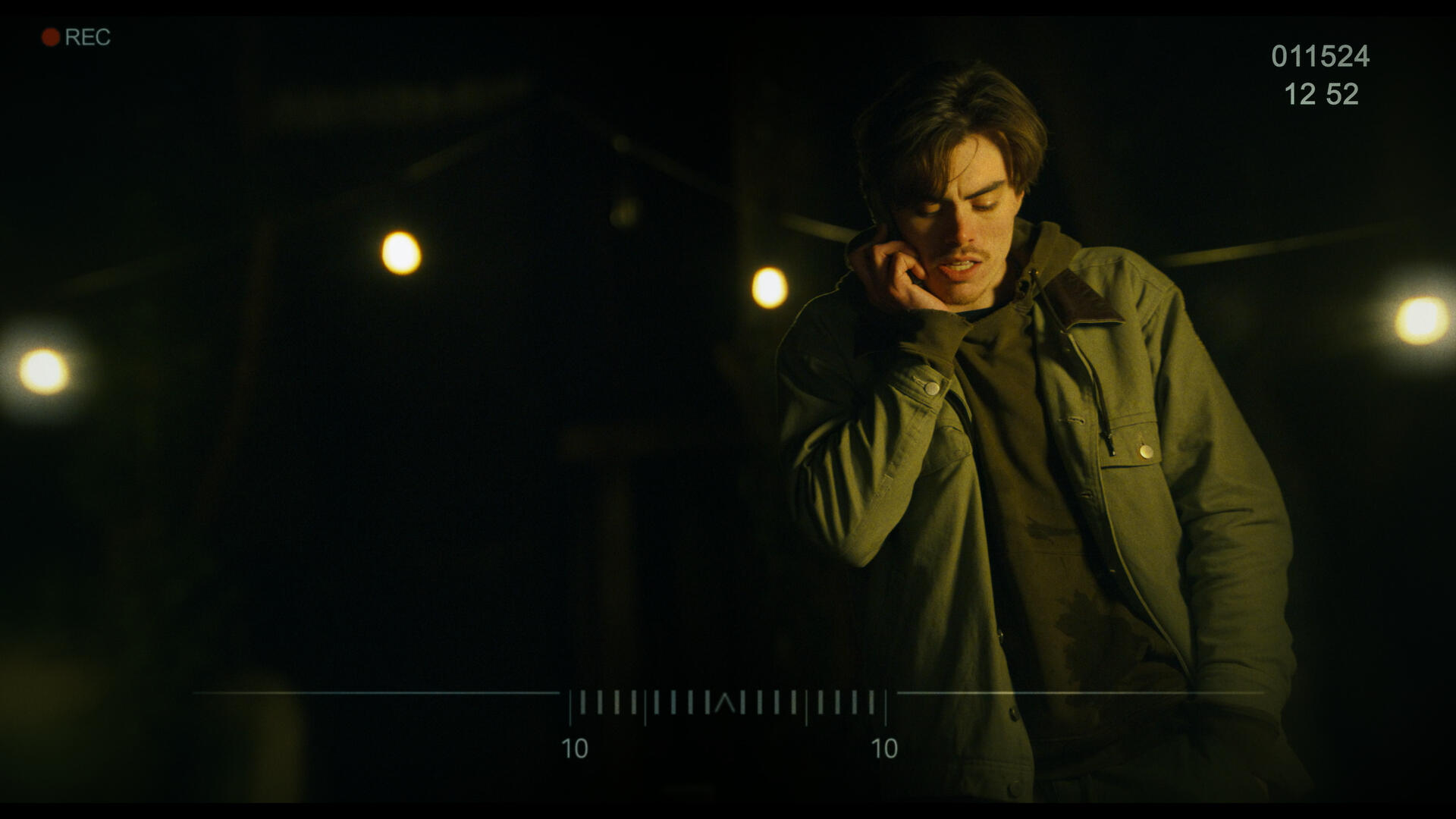 The antagonist of Working for the Weekend, as scene through a set of binoculars in a dark yard. It's lit by several warmly lit bulbs on a string.